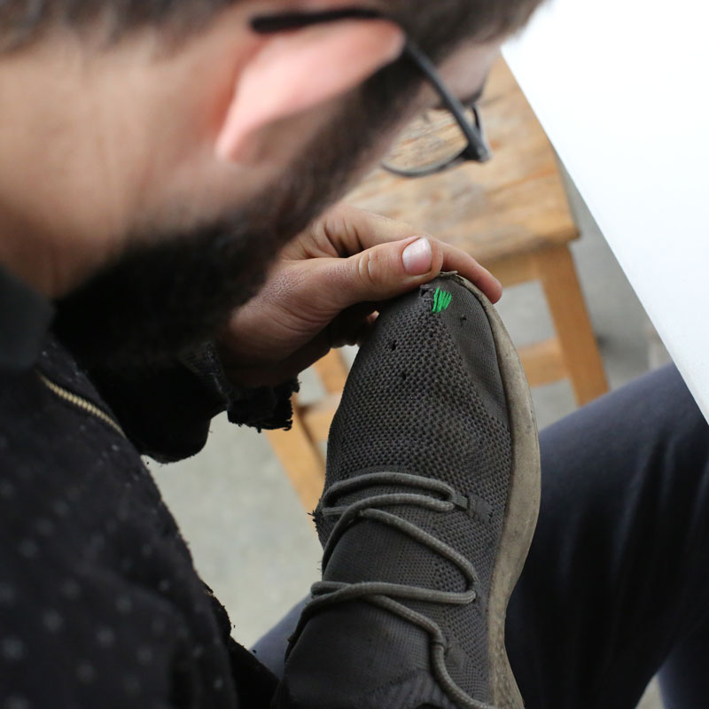 man fixing his shoe
